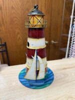 TIN LIGHTHOUSE WITH SEAGULLS AND A BOAT